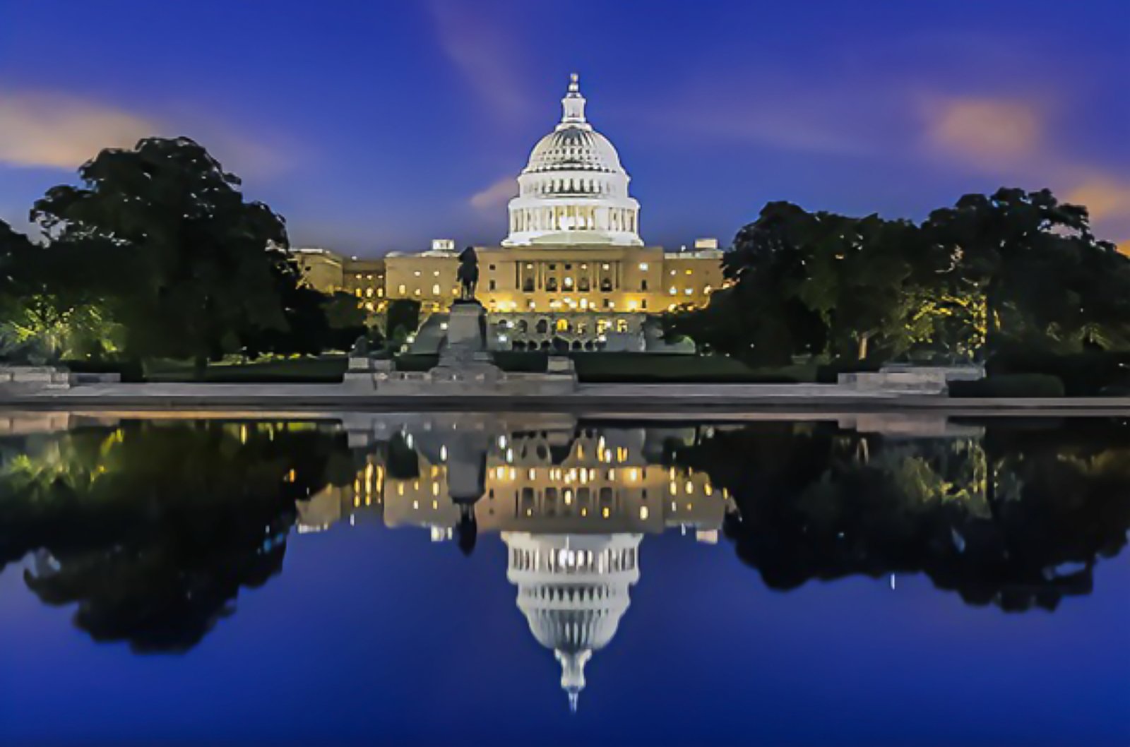 US Capitol at night, reflected in the reflecting pool